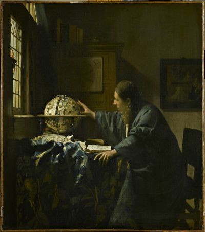 A white man in a blue robe sits at a desk before some papers and a globe. With one hand, he clutches a corner of the desk. With the other, he reaches out toward the globe. Light comes in through window, painting out a cabinet and a painting on his wall.