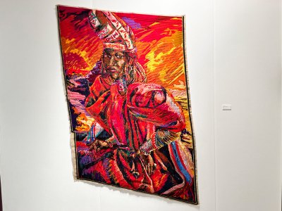 A tapestry showing a Black queer person in a regal magenta outfit.