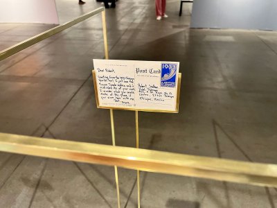Detail of a sculpture showing a postcard with a 1933 stamp on right, as well as Robert Smithson's address. At left is a message, generated using AI, from Frank Lloyd Wright to Smithson.