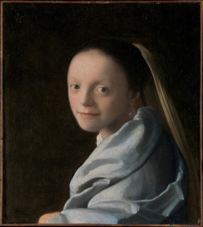 A young white woman with a blue drape around her gazes out toward the viewer. She is set against a deep black void, and she is half-turned, so that one arm appears balanced on an unseen ledge.
