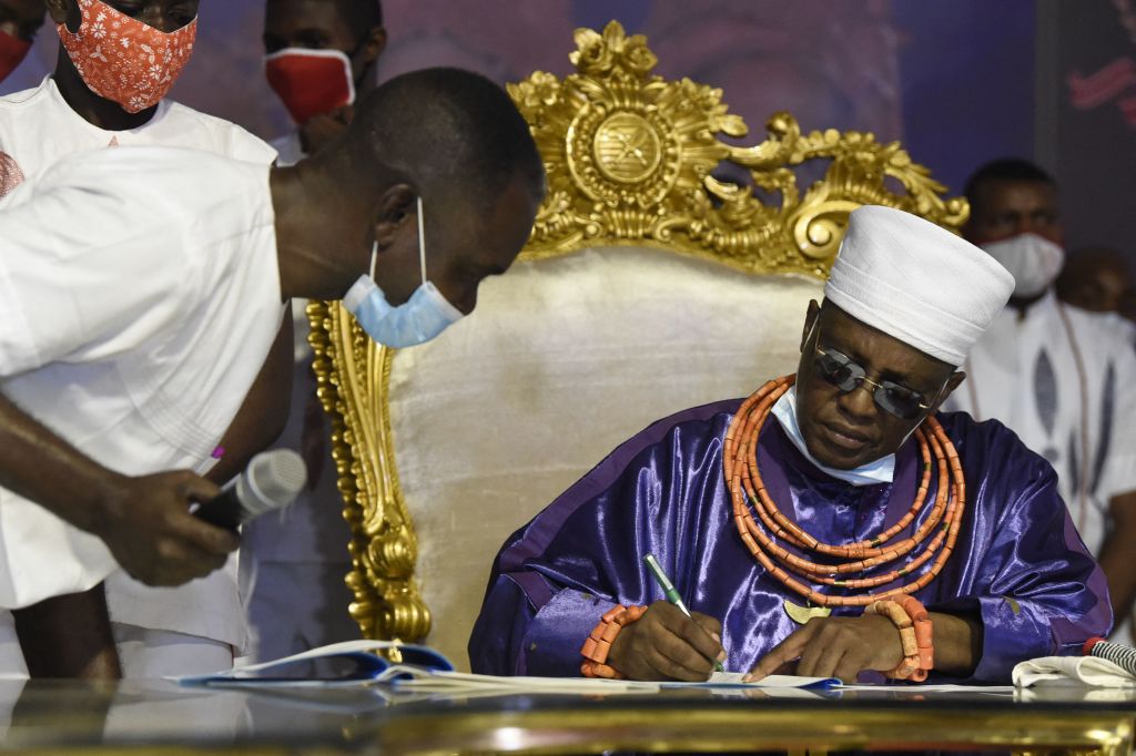 The Oba of Benin, Ewuare II, signs documents for the repartriation to the ancient kingdom of looted artifacts by the British military force in Benin City, Nigeria, 2021.