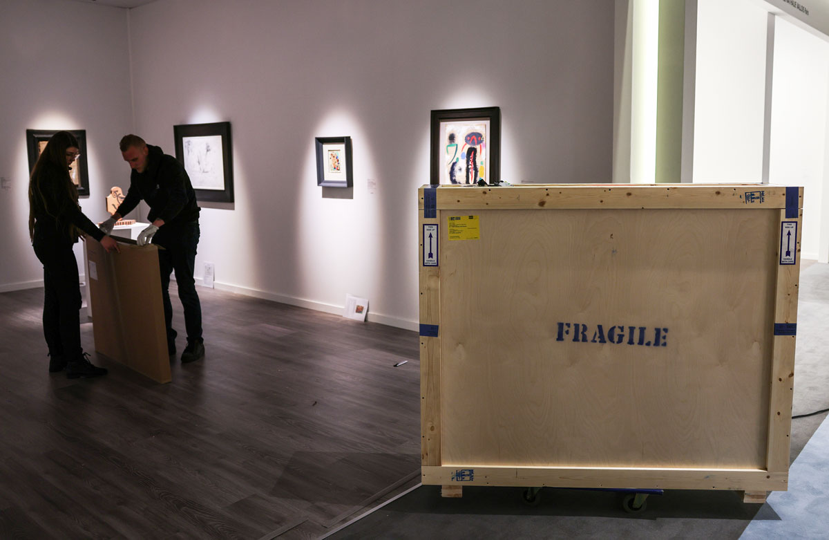 PRODUCTION - 08 March 2023, Netherlands, Maastricht: An art dealer unpacks paintings from shipping crates at the Tefaf art fair. For the first time in three years, the most important fair for old art is held on the regular date. Photo: Oliver Berg/dpa (Photo by Oliver Berg/picture alliance via Getty Images)