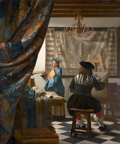 A white female model holds a book and a horn, and poses before a male painter whose back is turned away from the viewer. He begins to paint her blue crown of flowers on a canvas propped on an easel. Behind them hangs a large map and a chandelier with candles in it. A curtain has been pulled back to reveal the studio.