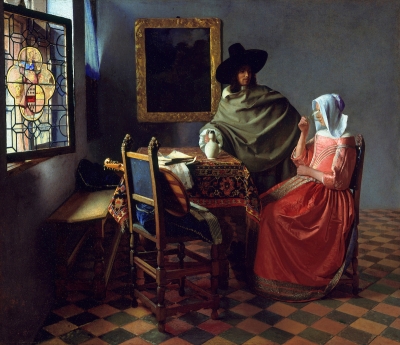 A seated woman in a pink dress and white veil drinks the last of a glass of wine. A white man in a green robe stands next to her, his hand on a jug on a table. A seat that has pushed out from the table holds a musical instrument and sheet music. A stained glass window lets light into the room, which has a tiled floor and a painting on its wall.