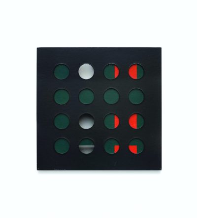 Black square with a grid of circular openings revealing white, red and green behind.